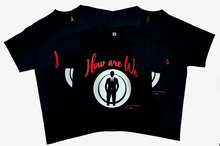 a black short-sleeve shirt true to size in red font that says "How are we?" Human character in black tux with hands in the pockets 